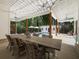 Inviting covered patio with dining table, outdoor lighting, and a glimpse of the serene pool area at 230 Pebble Trl, Alpharetta, GA 30009