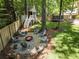 Relaxing backyard with a fire pit and playhouse at 230 Pebble Trl, Alpharetta, GA 30009