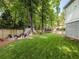 Grassy backyard with a fire pit, play house, and room to entertain at 230 Pebble Trl, Alpharetta, GA 30009