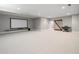 Spacious basement featuring a large media screen, sliding barn door, and neutral carpet at 230 Pebble Trl, Alpharetta, GA 30009