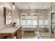 Spa-like bathroom featuring dual vanities, a freestanding tub, and natural light at 230 Pebble Trl, Alpharetta, GA 30009