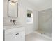 Stylish bathroom with marble countertop, subway tiles in the shower, and black and white penny tile flooring at 230 Pebble Trl, Alpharetta, GA 30009
