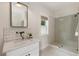 Elegant bathroom featuring a glass shower, a sink with a marble countertop, and sleek fixtures at 230 Pebble Trl, Alpharetta, GA 30009