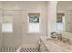 Elegant bathroom featuring a glass shower, marble countertop, decorative tiles, and a window at 230 Pebble Trl, Alpharetta, GA 30009