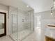 Large walk-in shower with marble tile, glass door, and hexagon tile floors at 230 Pebble Trl, Alpharetta, GA 30009