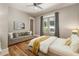 Bright bedroom featuring hardwood floors, French doors to the yard, and neutral decor at 230 Pebble Trl, Alpharetta, GA 30009