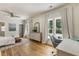 Bright bedroom featuring hardwood floors, neutral walls, a ceiling fan, and a comfortable work space at 230 Pebble Trl, Alpharetta, GA 30009