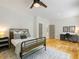 Cozy bedroom with natural light, includes a metal frame bed, vintage rug, and a study desk with chair at 230 Pebble Trl, Alpharetta, GA 30009