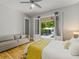 Bright bedroom featuring a ceiling fan and French doors leading to a backyard pool at 230 Pebble Trl, Alpharetta, GA 30009