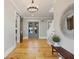 Entryway featuring wood floors, modern light fixture, and barn doors at 230 Pebble Trl, Alpharetta, GA 30009
