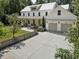 Charming two-story home with a three car garage, landscaped yard and walkway at 230 Pebble Trl, Alpharetta, GA 30009