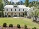 Beautiful modern farmhouse with a metal roof, covered porch, and well-manicured lawn at 230 Pebble Trl, Alpharetta, GA 30009