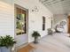 Inviting front porch with seating area and decorative plants at 230 Pebble Trl, Alpharetta, GA 30009