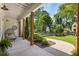 Inviting covered porch featuring stylish outdoor seating, wood columns, and a beautifully landscaped front yard at 230 Pebble Trl, Alpharetta, GA 30009
