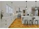 Bright, modern kitchen with white cabinets, marble countertops, and stainless steel appliances at 230 Pebble Trl, Alpharetta, GA 30009