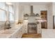 Charming kitchen with white cabinetry, stainless steel appliances, and marble countertops at 230 Pebble Trl, Alpharetta, GA 30009