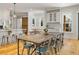 Well-appointed kitchen with white cabinetry and a rustic dining table at 230 Pebble Trl, Alpharetta, GA 30009