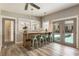 Stylish kitchenette with a bar, stools, and easy access to an outdoor pool and patio area at 230 Pebble Trl, Alpharetta, GA 30009
