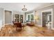 Inviting living room with hardwood floors, a statement chandelier, and a built-in bookcase at 230 Pebble Trl, Alpharetta, GA 30009