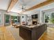 Cozy living room with a brick fireplace, wood beams, and comfortable seating at 230 Pebble Trl, Alpharetta, GA 30009