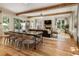 Open-concept living room and dining area with wood beams, a fireplace, and plenty of natural light at 230 Pebble Trl, Alpharetta, GA 30009
