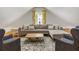 Inviting living room with a comfortable sectional sofa, a patterned rug, and two upholstered chairs at 230 Pebble Trl, Alpharetta, GA 30009