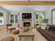 Warm living room featuring a brick fireplace, comfortable seating, and an area rug at 230 Pebble Trl, Alpharetta, GA 30009