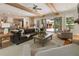 Bright and airy living room with exposed beams, hardwood floors, and sliding doors to the backyard at 230 Pebble Trl, Alpharetta, GA 30009