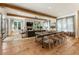 Spacious living room featuring a fireplace, wood beams, and large windows offering seamless indoor-outdoor living at 230 Pebble Trl, Alpharetta, GA 30009