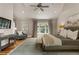 Light-filled main bedroom with hardwood floors, a sitting area, and a vaulted ceiling at 230 Pebble Trl, Alpharetta, GA 30009