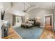 Spacious main bedroom with vaulted ceilings, a sitting area, and hardwood floors at 230 Pebble Trl, Alpharetta, GA 30009