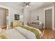 Serene main bedroom with hardwood floors, a neutral palette, a cozy couch, and ample natural light at 230 Pebble Trl, Alpharetta, GA 30009