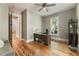 Stylish home office featuring natural light, hardwood floors, and a modern desk at 230 Pebble Trl, Alpharetta, GA 30009