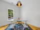 Bright, minimalist office with a glass desk, vintage rug, and plenty of natural light streaming through the window at 230 Pebble Trl, Alpharetta, GA 30009