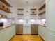 Walk-in pantry with wood shelves, farmhouse sink, stainless dishwasher and tiled backsplash at 230 Pebble Trl, Alpharetta, GA 30009