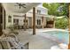 Spacious outdoor patio with ceiling fans, dining area, lounge seating, and an inviting in-ground pool at 230 Pebble Trl, Alpharetta, GA 30009
