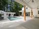 Beautiful backyard featuring a sparkling pool, a pool house, an umbrella, and outdoor furniture at 230 Pebble Trl, Alpharetta, GA 30009