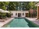 Beautiful pool house with a modern design, adjacent to the refreshing in-ground pool and lounge chairs at 230 Pebble Trl, Alpharetta, GA 30009