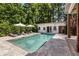 Beautiful backyard pool surrounded by lush greenery and comfortable lounge seating at 230 Pebble Trl, Alpharetta, GA 30009
