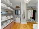 Well-organized walk-in closet with ample storage, shelving, and a chandelier at 230 Pebble Trl, Alpharetta, GA 30009