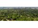 View of the surrounding neighborhood featuring lush tree coverage and a skyline view at 5155 Pine Branch Pt, Atlanta, GA 30338