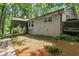 Home's backyard with brick walkway and deck. The yard is surrounded by trees and landscaping at 5155 Pine Branch Pt, Atlanta, GA 30338