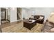 Finished basement featuring a seating area with plush sofas, stairs, and an access door at 5155 Pine Branch Pt, Atlanta, GA 30338
