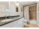 Granite countertop bathroom featuring double sinks, white cabinets, shower with curtain, and tile flooring at 5155 Pine Branch Pt, Atlanta, GA 30338