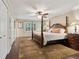 Main bedroom with hardwood floors and ensuite bathroom at 5155 Pine Branch Pt, Atlanta, GA 30338