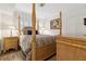 This bedroom features a four-poster bed, hardwood floors, and bright natural light at 5155 Pine Branch Pt, Atlanta, GA 30338