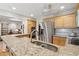 Spacious kitchen with stainless steel refrigerator, granite counters, and light wooden cabinets at 5155 Pine Branch Pt, Atlanta, GA 30338