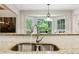 Kitchen sink overlooking backyard through window at 5155 Pine Branch Pt, Atlanta, GA 30338