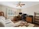 Functional office space with natural light, hardwood floors, a comfortable sofa, and ample work area at 5155 Pine Branch Pt, Atlanta, GA 30338