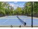 View of well-maintained tennis courts surrounded by lush greenery, ready for a competitive match at 5155 Pine Branch Pt, Atlanta, GA 30338